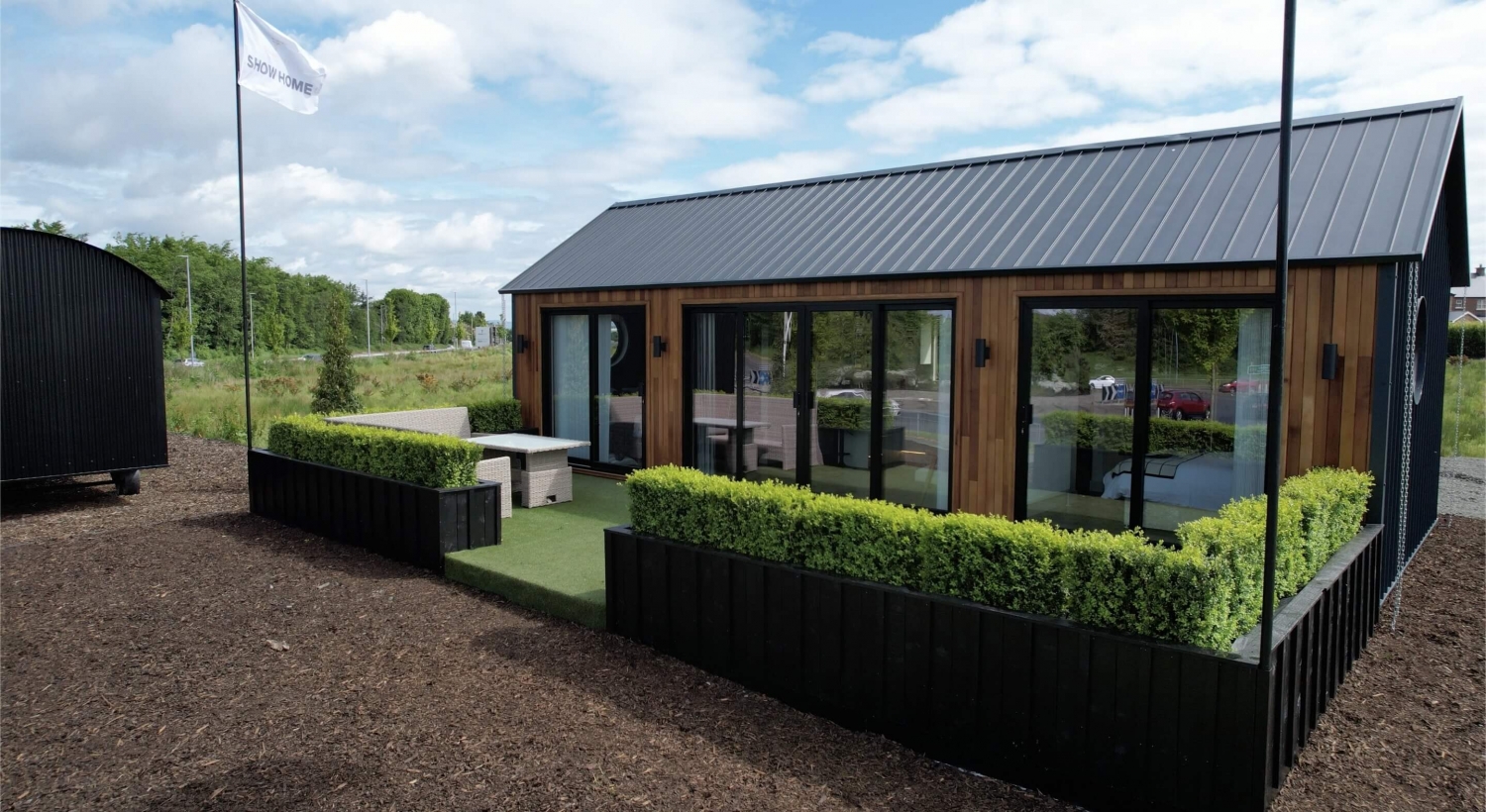 Cottage exterior — cedar-clad with black metal roof