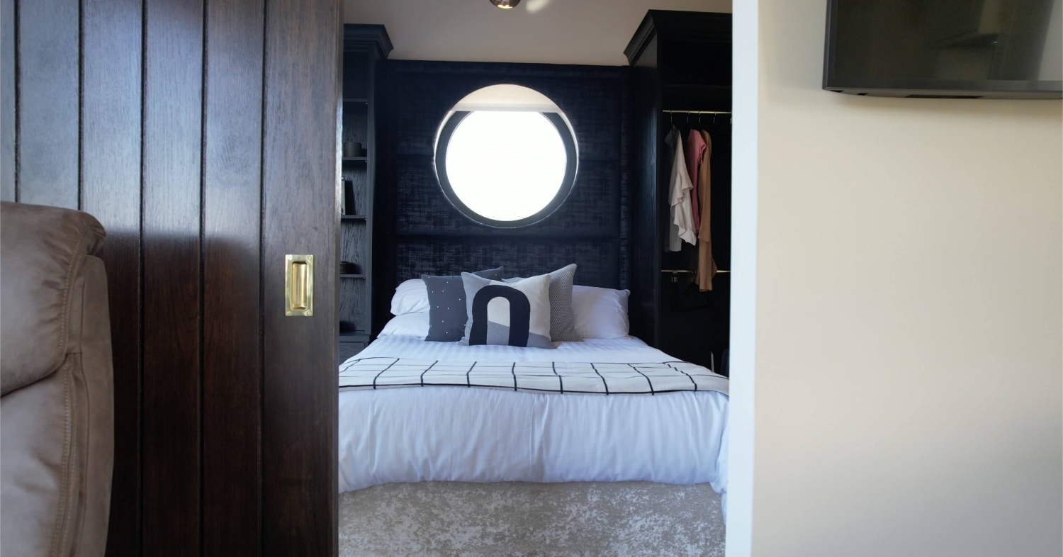 Cottage interior — bedroom with porthole window